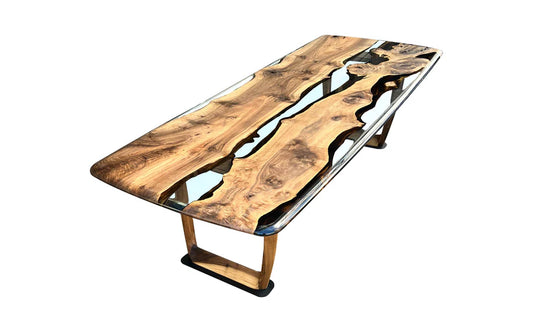 A handcrafted epoxy dining table with walnut wood and a clear resin finish, displayed in a minimalist dining room.