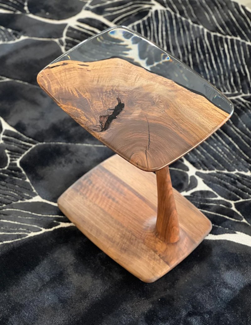 walnut - resin end table on a black premium carpet.